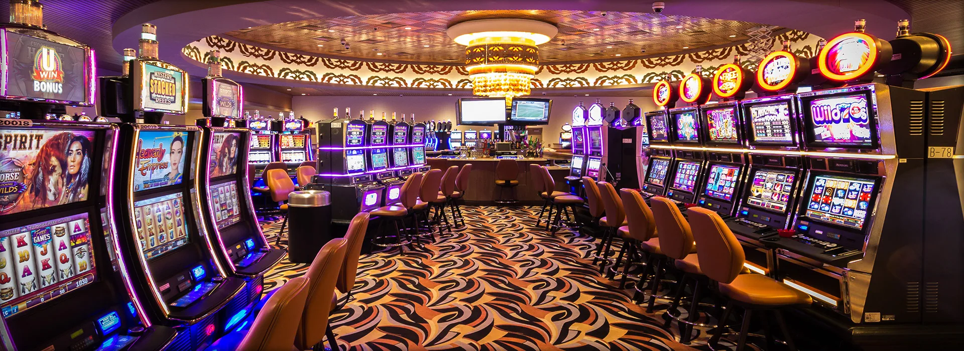 Rows of illuminated slot machines inside WinnaVegas Casino Resort.